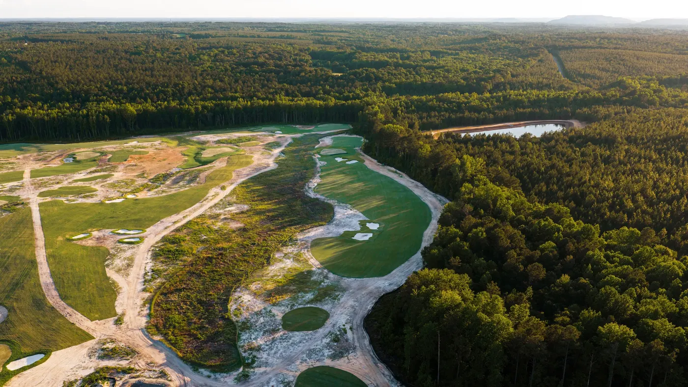 Candyroot's first hole from directly above, with the green set into sandy waste